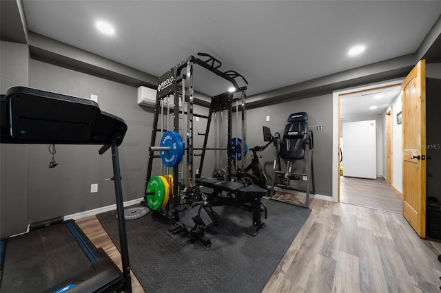 workout room featuring wood finished floors, baseboards, and recessed lighting