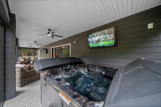view of patio / terrace featuring ceiling fan and a hot tub
