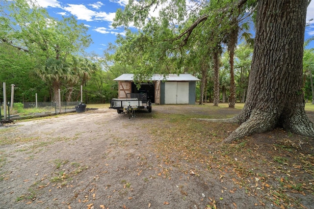 view of yard with an outdoor structure and fence