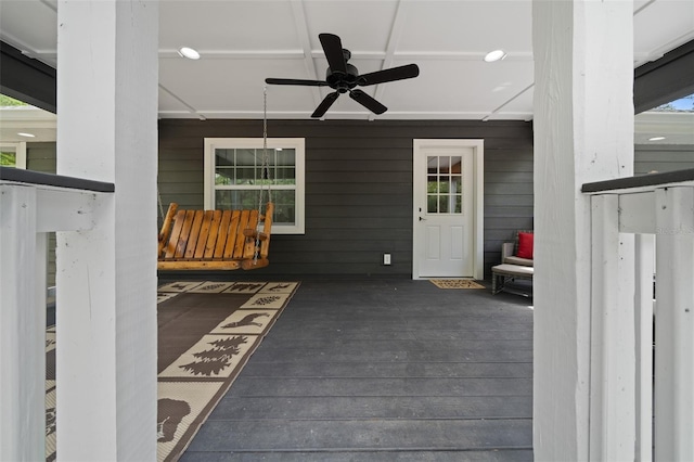 entrance to property featuring covered porch and a ceiling fan