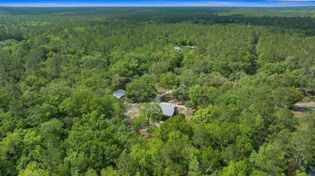 birds eye view of property featuring a view of trees
