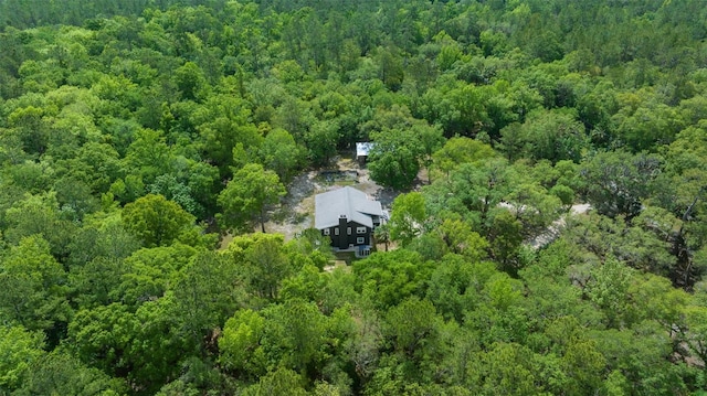 birds eye view of property featuring a forest view