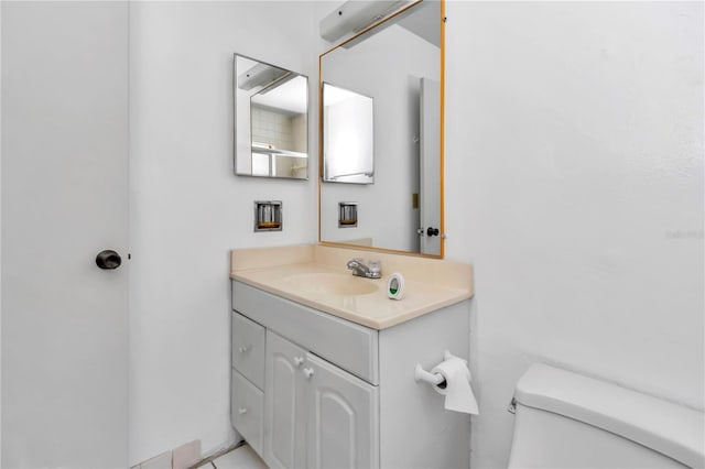 half bathroom featuring toilet and vanity
