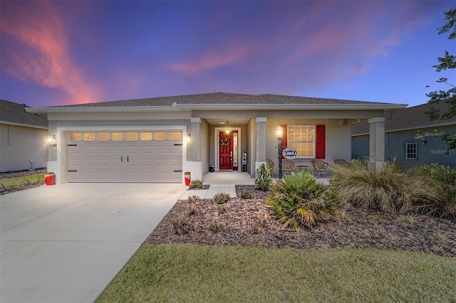 ranch-style house featuring stucco siding, driveway, a porch, and a garage
