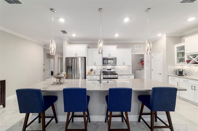 kitchen featuring marble finish floor, washer / clothes dryer, stainless steel appliances, and visible vents