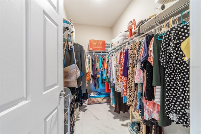 spacious closet featuring marble finish floor