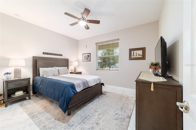 bedroom with marble finish floor and ceiling fan
