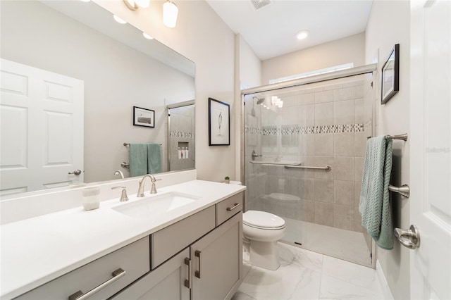bathroom with recessed lighting, marble finish floor, toilet, vanity, and a stall shower