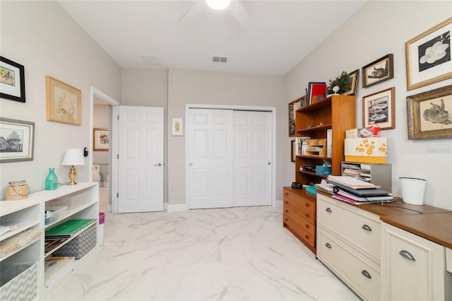 office area featuring marble finish floor, a ceiling fan, and visible vents