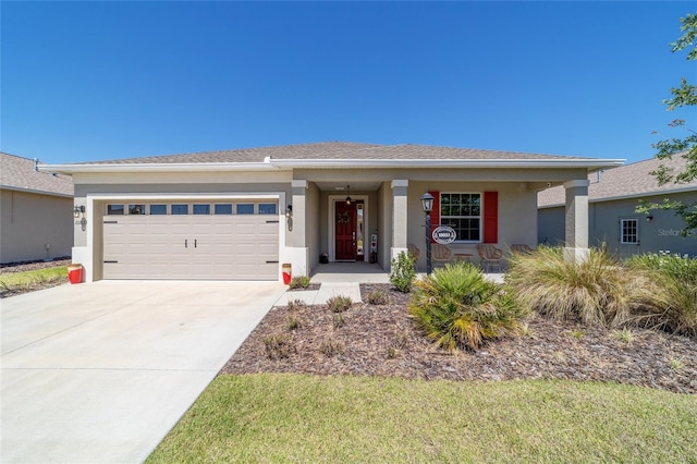 view of front facade with a garage, stucco siding, covered porch, and concrete driveway
