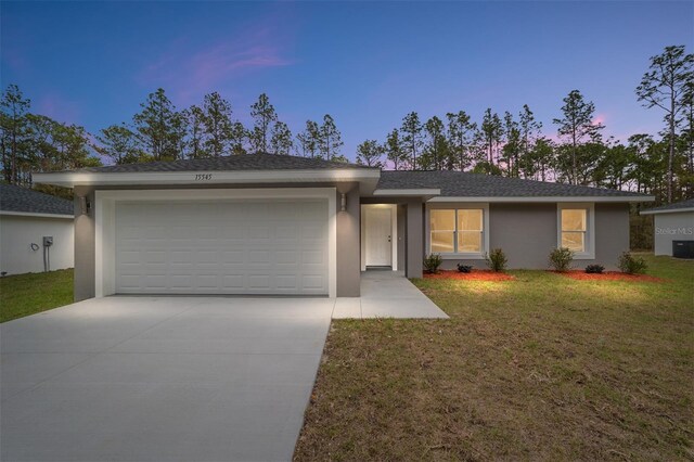 15840 SW 38th Pl, Ocala, FL 34481 - ranch-style house featuring a front yard, a shingled roof, a garage, stucco siding, and driveway