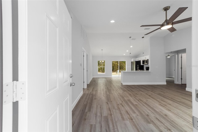 15840 SW 38th Pl, Ocala, FL 34481 - unfurnished living room with baseboards, ceiling fan, light wood-style floors, recessed lighting, and vaulted ceiling