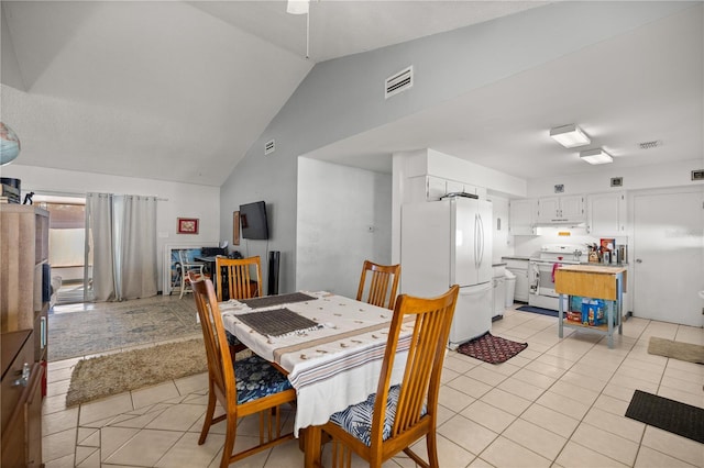 dining room with light tile patterned floors, lofted ceiling, and visible vents