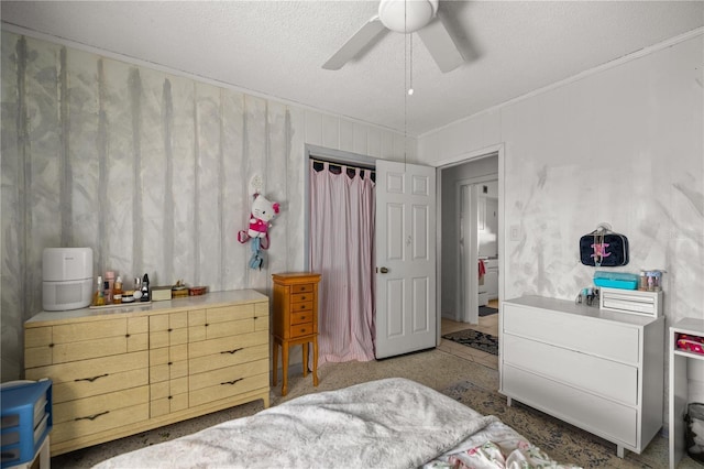 bedroom with ceiling fan and a textured ceiling