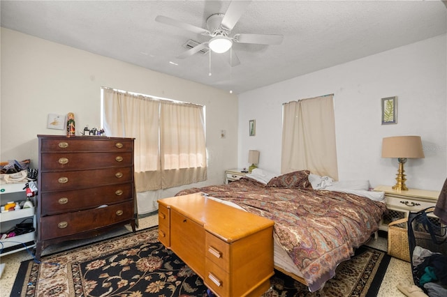 bedroom featuring a textured ceiling and ceiling fan
