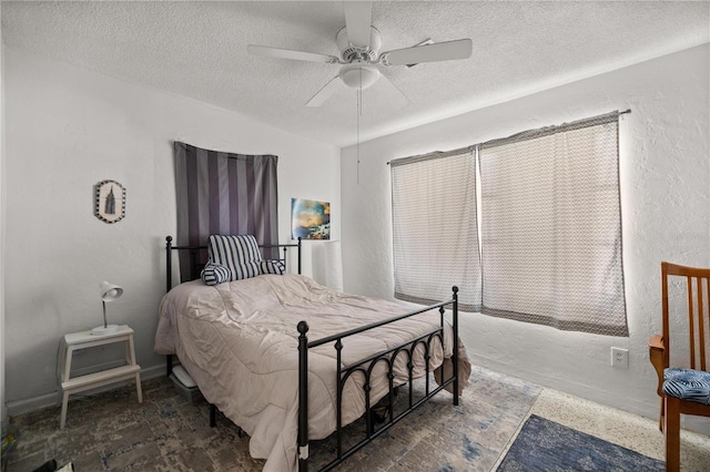 bedroom with a textured wall, a textured ceiling, and ceiling fan