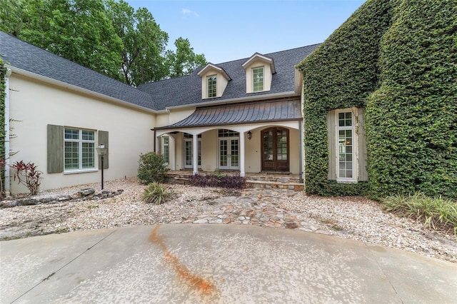 1251 SW 43rd Pl, Ocala, FL 34471 - view of front of property with french doors, stucco siding, a shingled roof, and a porch