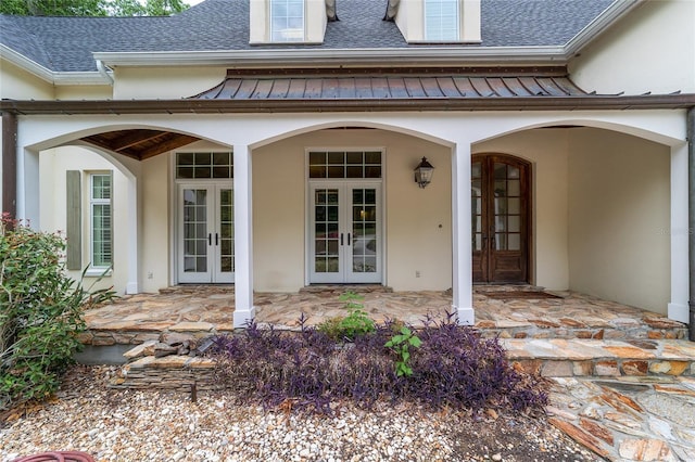 1251 SW 43rd Pl, Ocala, FL 34471 - doorway to property featuring french doors, a standing seam roof, a shingled roof, and stucco siding