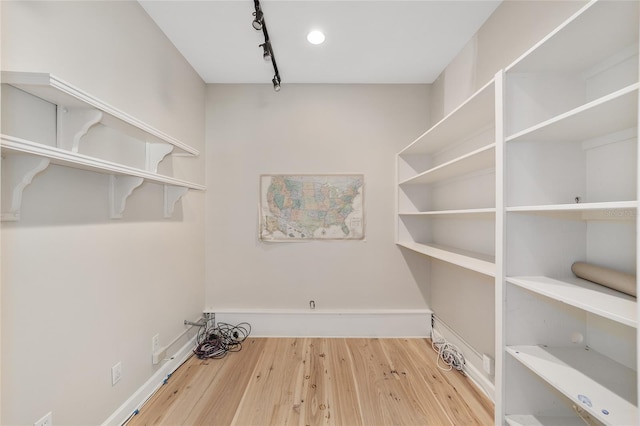 1251 SW 43rd Pl, Ocala, FL 34471 - laundry room with rail lighting, wood finished floors, and baseboards