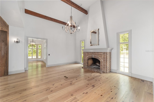 1251 SW 43rd Pl, Ocala, FL 34471 - unfurnished living room with a chandelier, high vaulted ceiling, plenty of natural light, light wood-style floors, and beamed ceiling