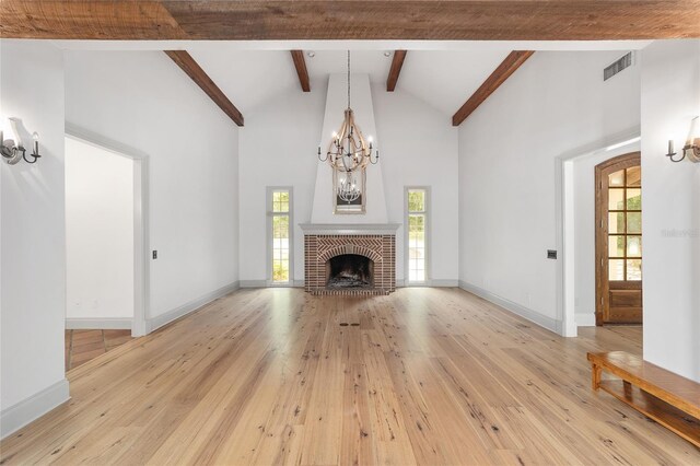 1251 SW 43rd Pl, Ocala, FL 34471 - unfurnished living room featuring a chandelier, light wood-style flooring, beamed ceiling, baseboards, and high vaulted ceiling