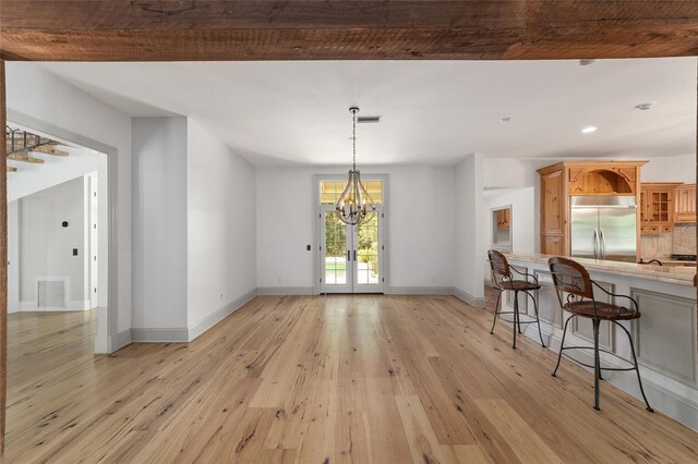 1251 SW 43rd Pl, Ocala, FL 34471 - dining space featuring light wood-type flooring, a chandelier, baseboards, recessed lighting, and french doors