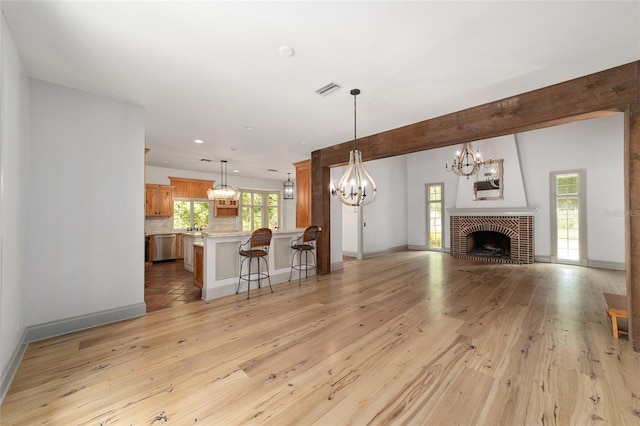 1251 SW 43rd Pl, Ocala, FL 34471 - unfurnished living room with a chandelier, light wood-style flooring, baseboards, healthy amount of natural light, and recessed lighting
