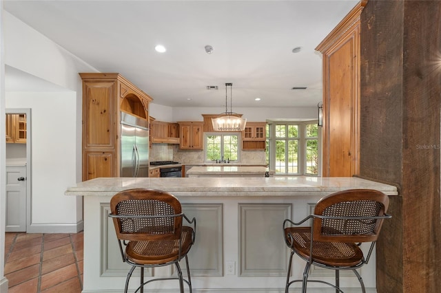 1251 SW 43rd Pl, Ocala, FL 34471 - kitchen featuring built in fridge, a peninsula, decorative backsplash, recessed lighting, and a sink