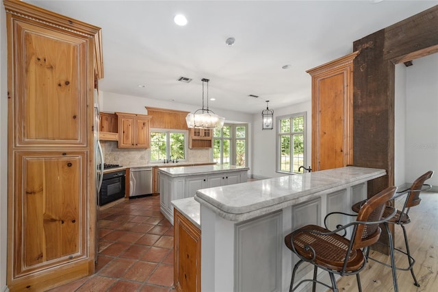 1251 SW 43rd Pl, Ocala, FL 34471 - kitchen featuring appliances with stainless steel finishes, a center island, a peninsula, tasteful backsplash, and recessed lighting