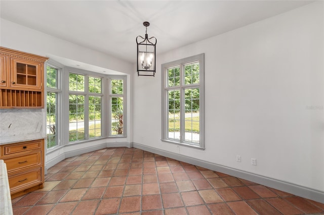 1251 SW 43rd Pl, Ocala, FL 34471 - unfurnished dining area with a chandelier and baseboards