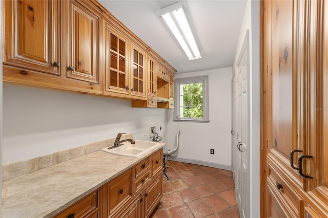 1251 SW 43rd Pl, Ocala, FL 34471 - washroom with cabinet space, washer hookup, baseboards, and light tile patterned flooring