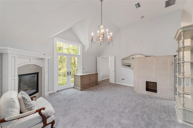 1251 SW 43rd Pl, Ocala, FL 34471 - living area featuring light carpet, a fireplace, french doors, a chandelier, and high vaulted ceiling