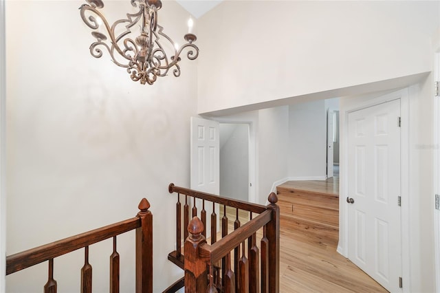 1251 SW 43rd Pl, Ocala, FL 34471 - corridor with a chandelier, light wood-style floors, and an upstairs landing