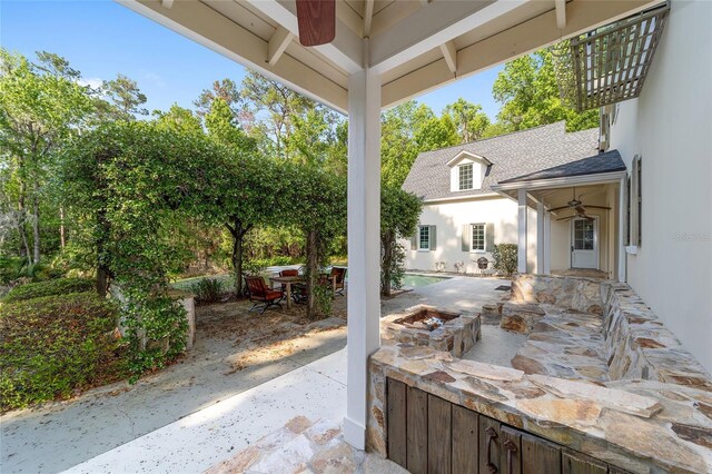 1251 SW 43rd Pl, Ocala, FL 34471 - view of patio / terrace featuring a fire pit, ceiling fan, and outdoor dining area