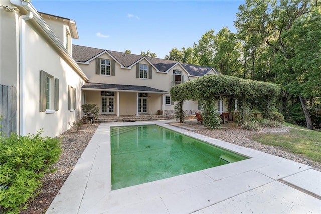 1251 SW 43rd Pl, Ocala, FL 34471 - rear view of property with french doors, stucco siding, an outdoor pool, and a patio area