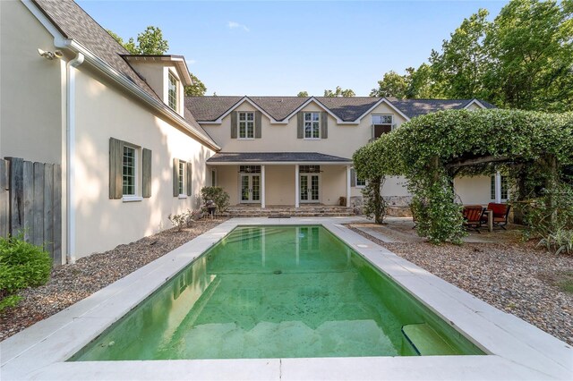 1251 SW 43rd Pl, Ocala, FL 34471 - rear view of house featuring french doors, stucco siding, an outdoor pool, fence, and a patio area