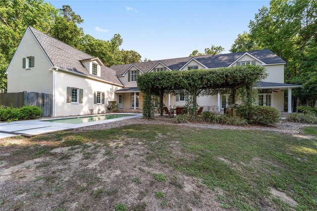 1251 SW 43rd Pl, Ocala, FL 34471 - back of house with stucco siding, fence, a patio, and a shingled roof