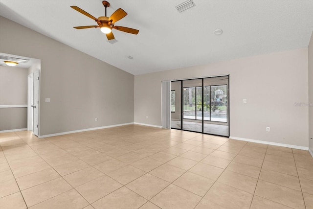empty room featuring ceiling fan, light tile patterned floors, vaulted ceiling, visible vents, and baseboards
