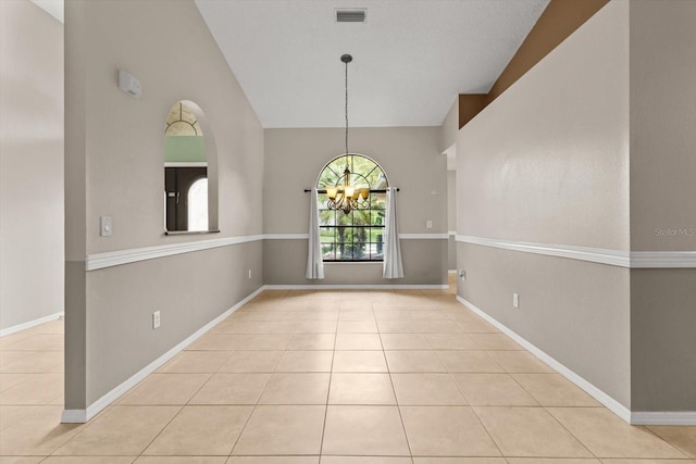 unfurnished dining area featuring a chandelier, tile patterned floors, baseboards, and visible vents