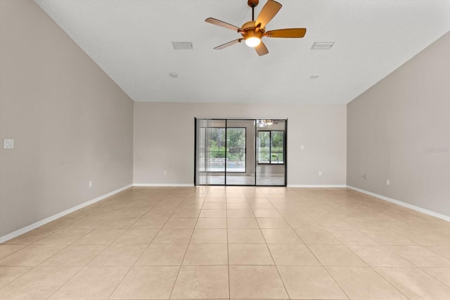 empty room with light tile patterned floors, visible vents, baseboards, and ceiling fan