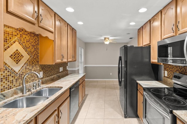kitchen with light stone countertops, a ceiling fan, light tile patterned flooring, a sink, and stainless steel appliances