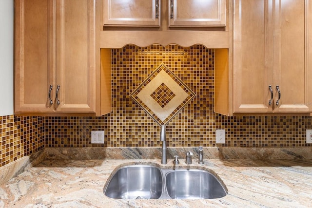kitchen featuring light stone counters and decorative backsplash
