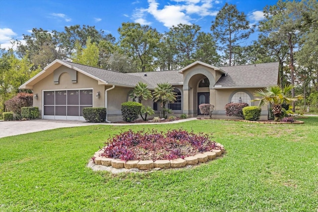 ranch-style home featuring roof with shingles, a front lawn, driveway, and stucco siding