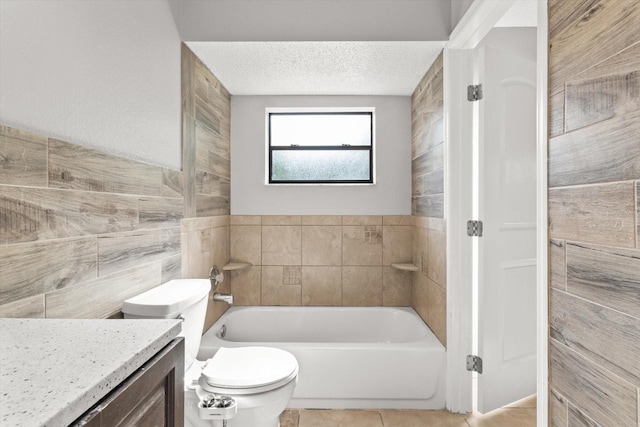 bathroom featuring a bath, toilet, tile walls, a textured ceiling, and tile patterned flooring