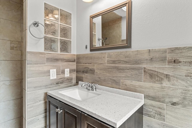 bathroom with tile walls and vanity