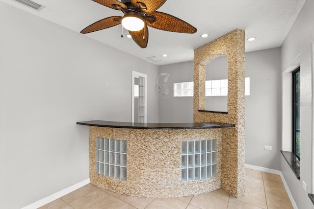 kitchen with tile patterned flooring, visible vents, baseboards, and ceiling fan