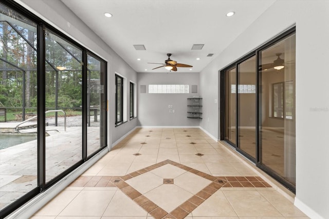 unfurnished sunroom featuring plenty of natural light and visible vents