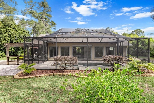 rear view of house featuring a pergola, a patio, and a lanai
