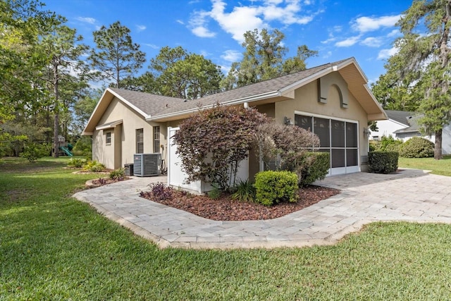 view of property exterior with central air condition unit, stucco siding, and a lawn