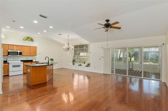 kitchen with visible vents, stainless steel microwave, recessed lighting, ceiling fan with notable chandelier, and electric range